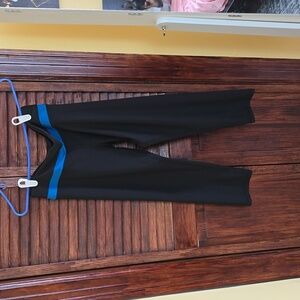 Small black gym pants with blue strip, capris